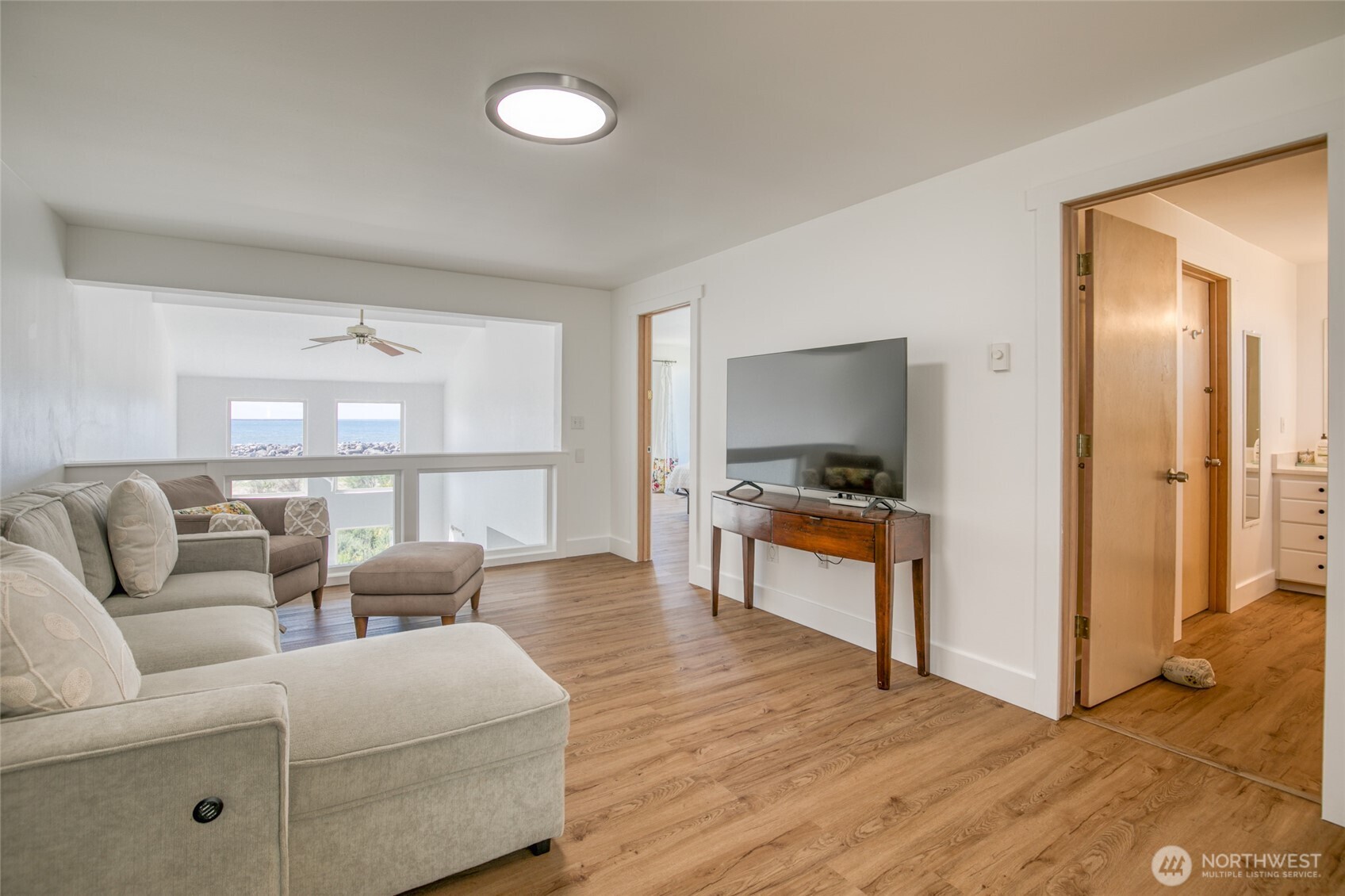 1472 Storm King Way Southwest, Unit A Ocean Shores, WA 98569 - Photo 25 of 39 a living room with furniture and a kitchen