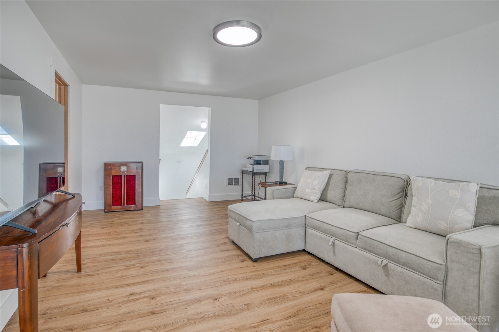1472 Storm King Way Southwest, Unit A Ocean Shores, WA 98569 - Photo 26 of 39 a living room with furniture and a lamp