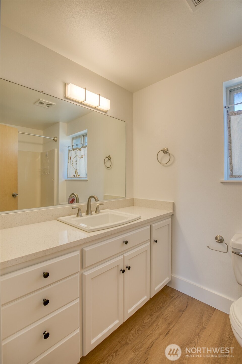1472 Storm King Way Southwest, Unit A Ocean Shores, WA 98569 - Photo 32 of 39 a bathroom with a sink and a mirror