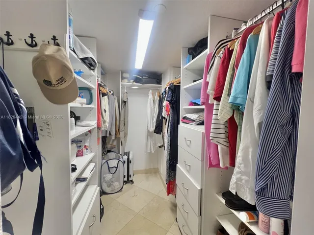 a bathroom with a bathtub shower sink and mirror