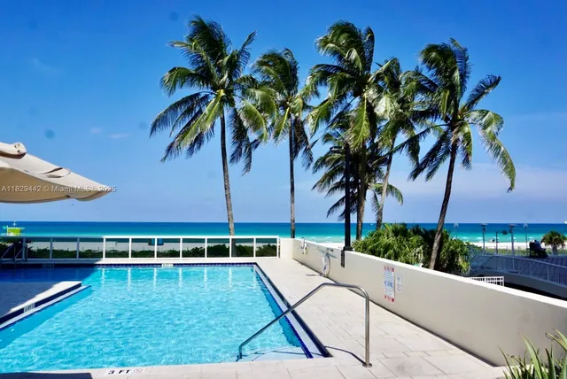 a view of a swimming pool and lounge chairs