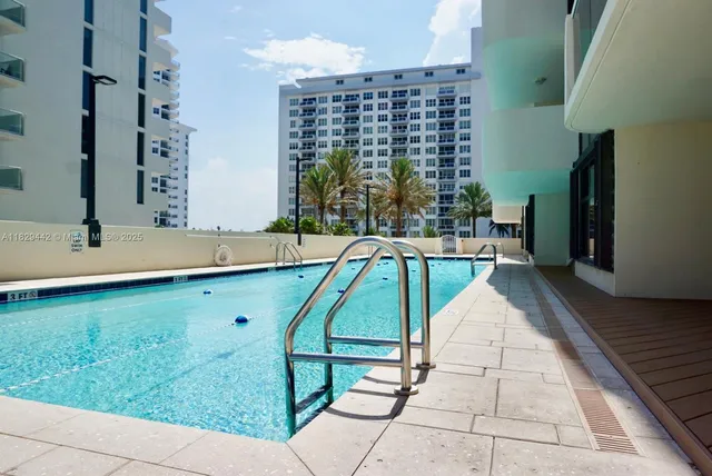 a kitchen with granite countertop a refrigerator and a stove top oven