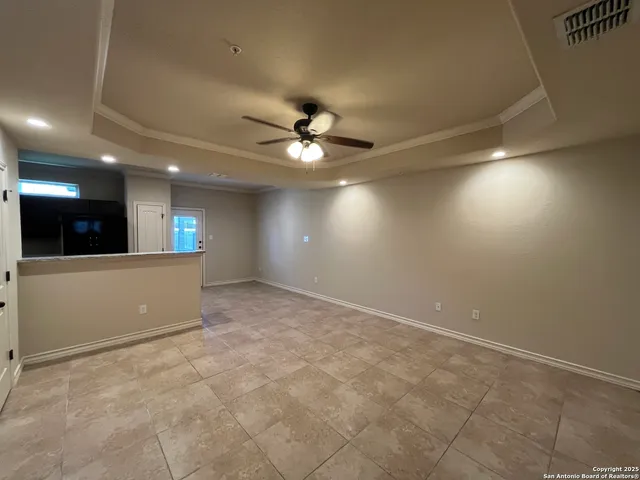 a view of an empty room with a ceiling fan