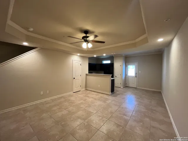 a view of a livingroom with a ceiling fan and window