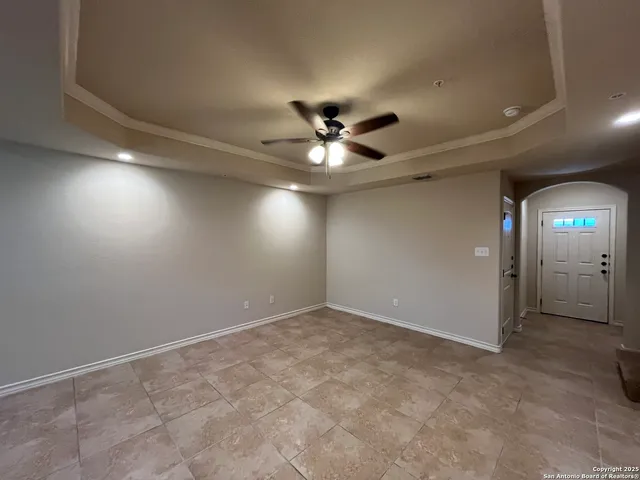 en view of an empty room and a ceiling fan
