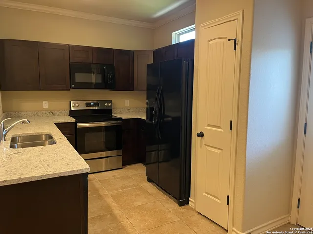 a kitchen with a refrigerator stove and sink