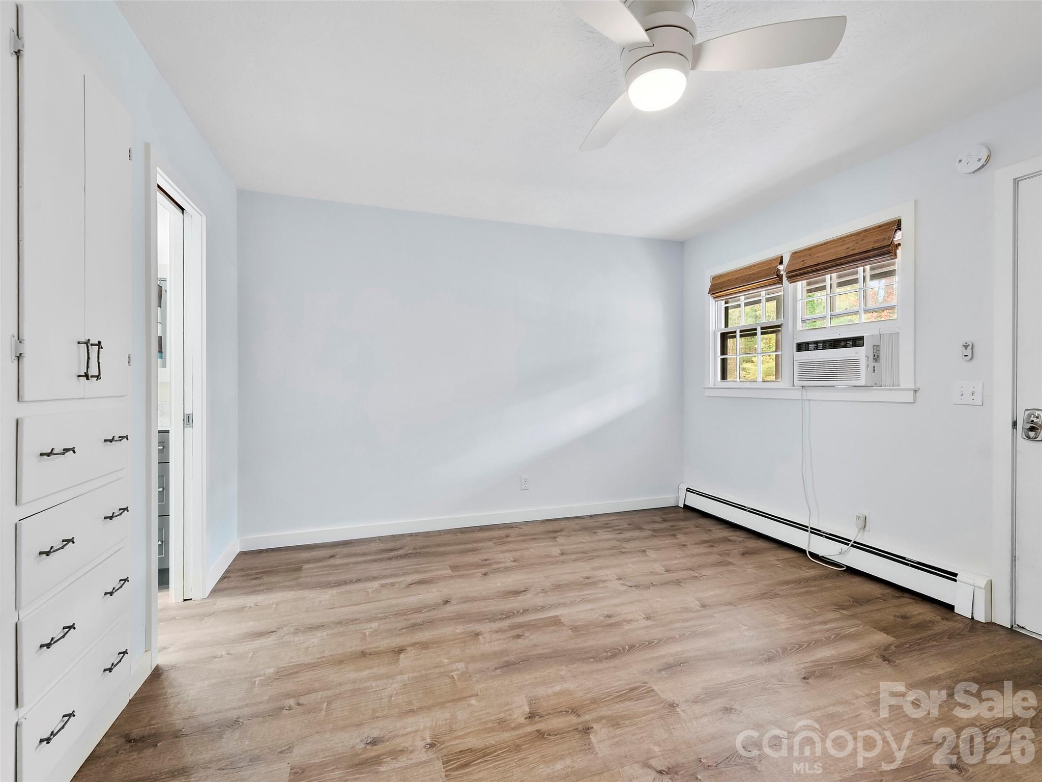 130 Old Mill Road, Unit 223 Flat Rock, NC 28731 - Photo 15 of 24 wooden floor in an empty room with a window
