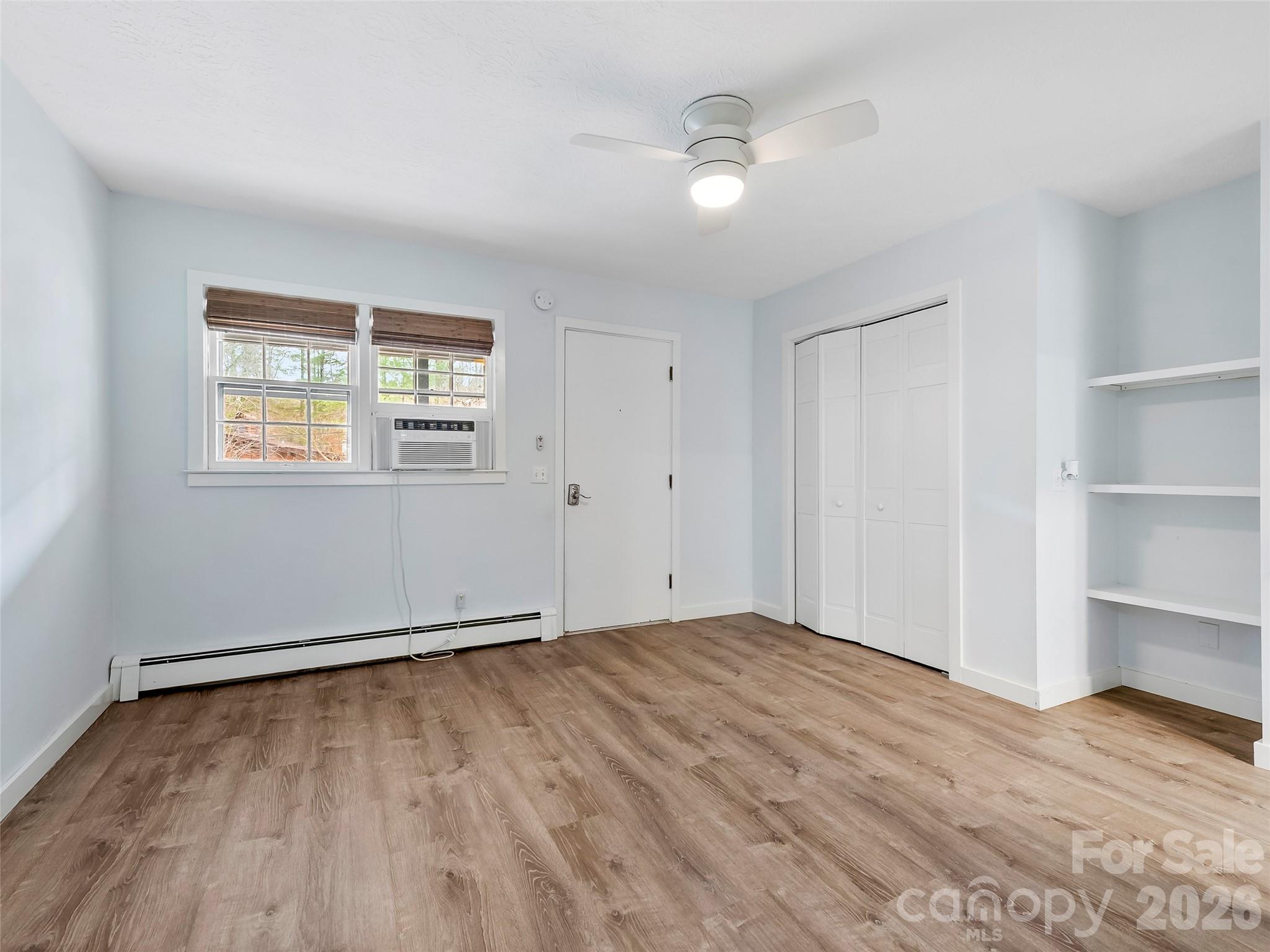 130 Old Mill Road, Unit 223 Flat Rock, NC 28731 - Photo 18 of 24 wooden floor in an empty room with a window