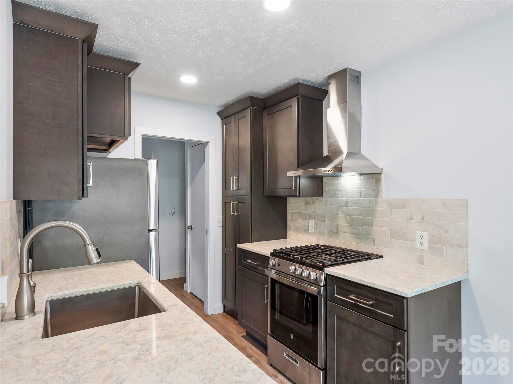 130 Old Mill Road, Unit 223 Flat Rock, NC 28731 - Photo 2 of 24 a kitchen with granite countertop a stove and a sink