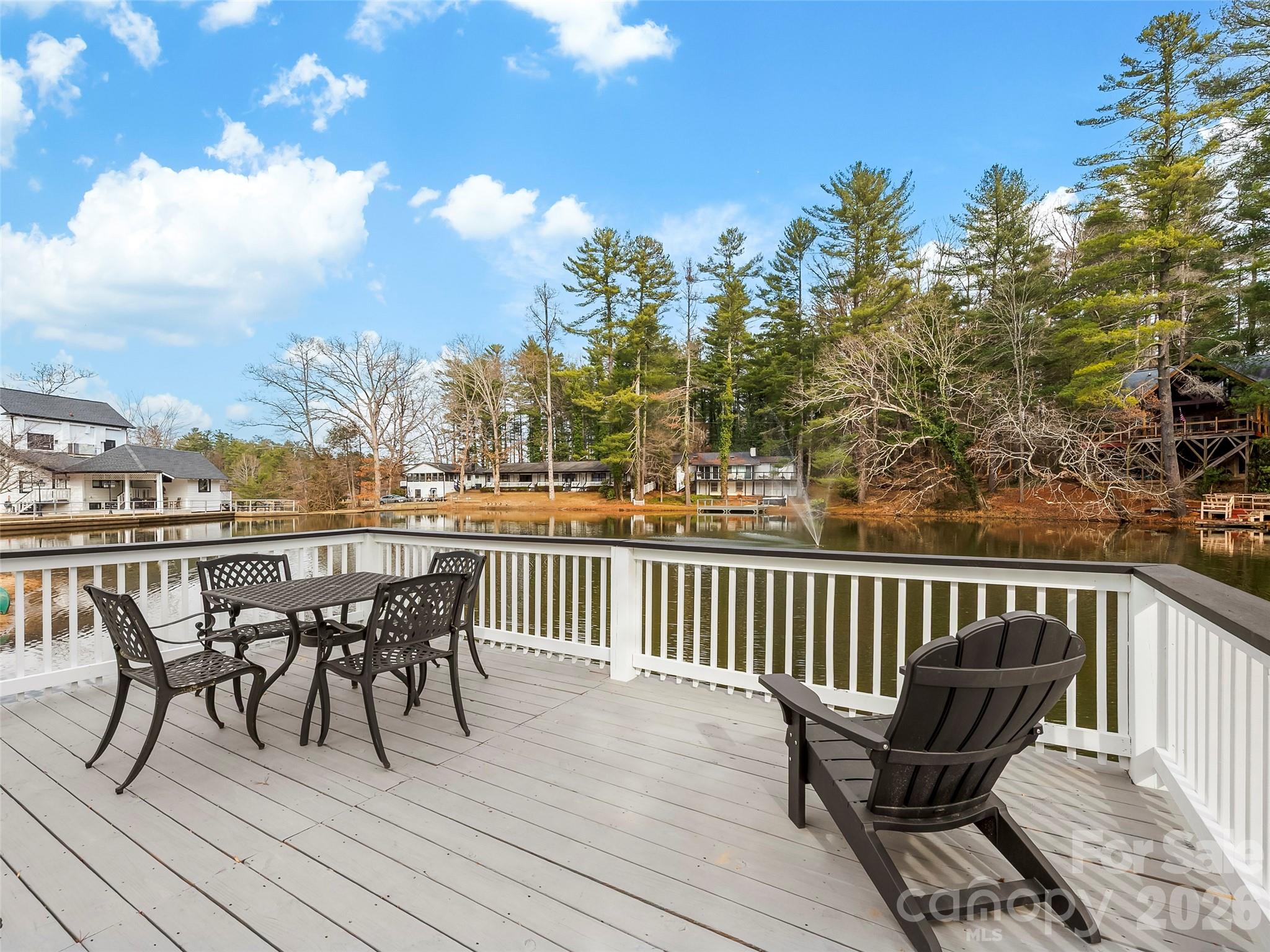 130 Old Mill Road, Unit 223 Flat Rock, NC 28731 - Photo 24 of 24 a view of a deck with table and chairs and wooden floor