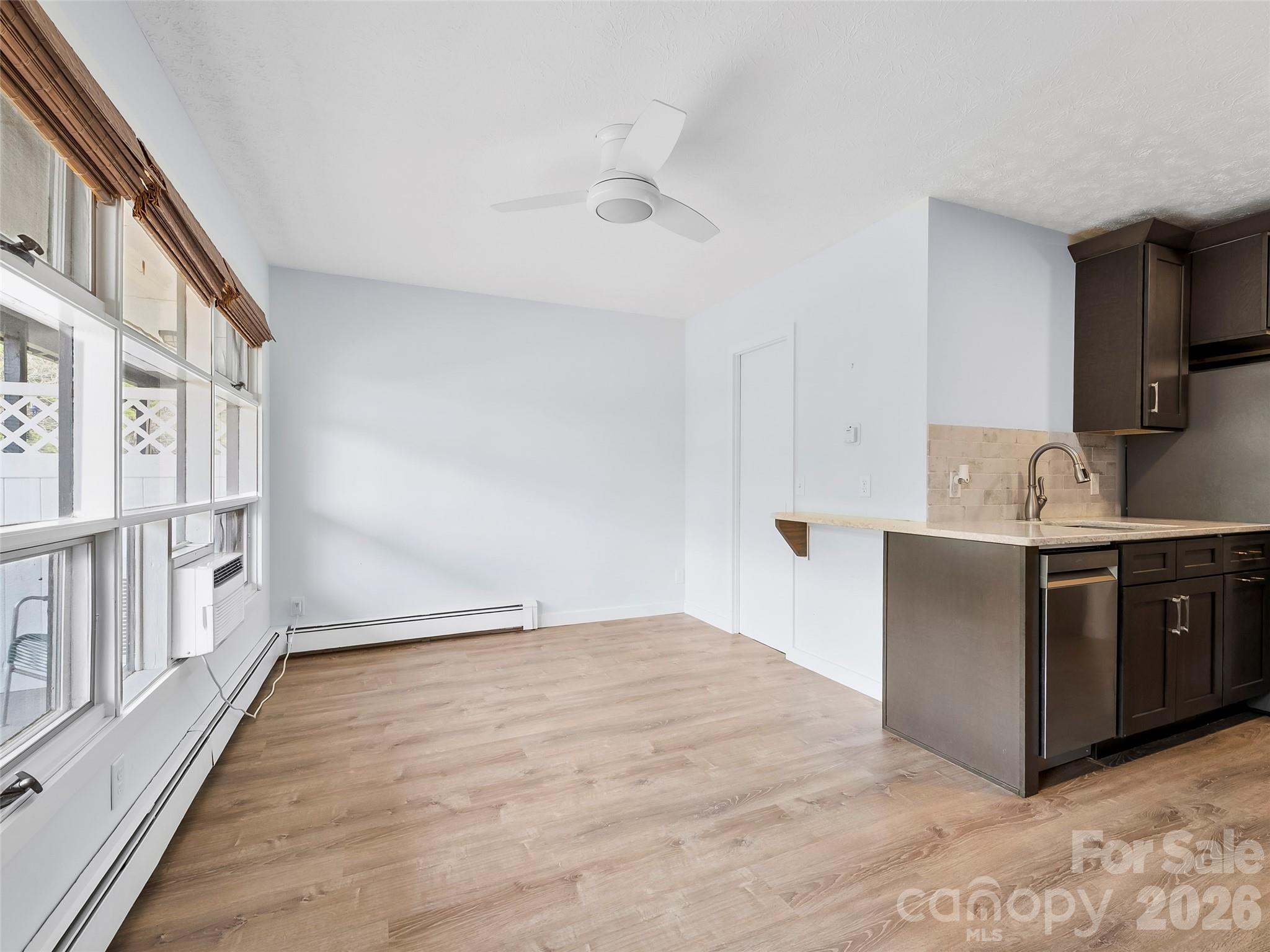 130 Old Mill Road, Unit 223 Flat Rock, NC 28731 - Photo 5 of 24 a kitchen with stainless steel appliances granite countertop a refrigerator and a sink