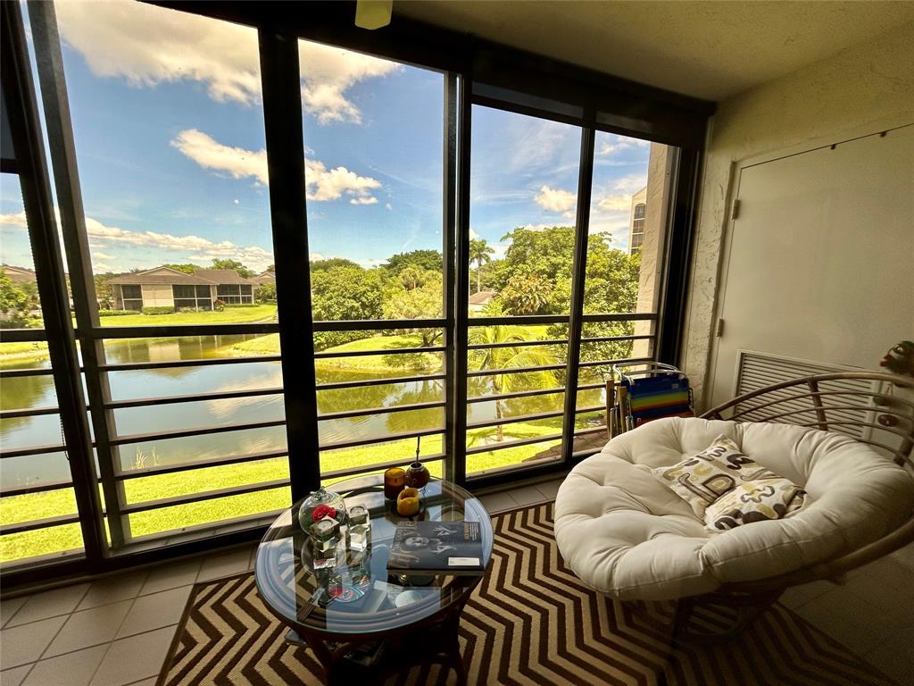 a living room with furniture and a floor to ceiling window