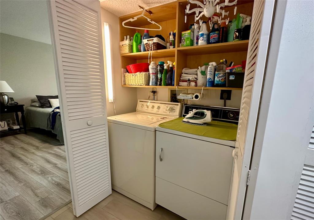7582 Regency Lake Drive, Unit 301 Boca Raton, FL 33433 - Photo 12 of 20 a utility room with dryer and washer