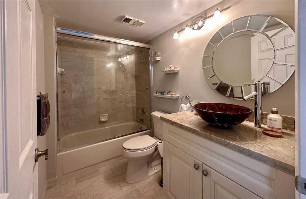7582 Regency Lake Drive, Unit 301 Boca Raton, FL 33433 - Photo 14 of 20 a bathroom with a granite countertop sink mirror toilet and bathtub