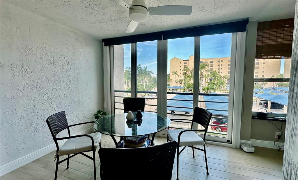 7582 Regency Lake Drive, Unit 301 Boca Raton, FL 33433 - Photo 19 of 20 a view of a dining room with furniture and wooden floor