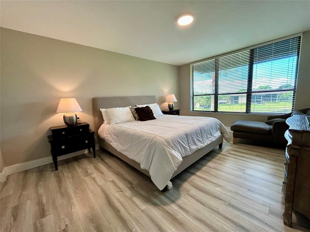 7582 Regency Lake Drive, Unit 301 Boca Raton, FL 33433 - Photo 8 of 20 a bedroom with a bed and a large window