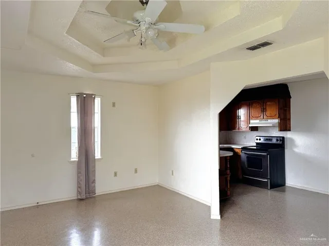an empty room with furniture and wooden floor