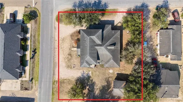 aerial view of a house with a yard and garden