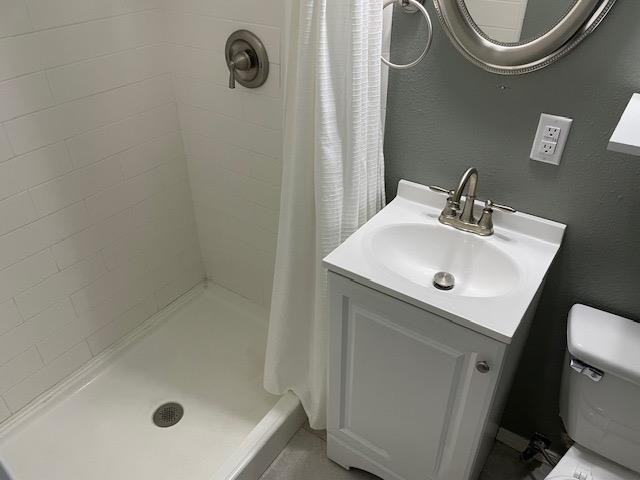 3018 32nd Street Lubbock, TX 79410 - Photo 17 of 33 a bathroom with a sink a toilet and a mirror