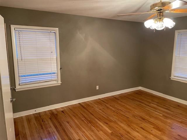 3018 32nd Street Lubbock, TX 79410 - Photo 19 of 33 a view of an empty room with wooden floor and a window