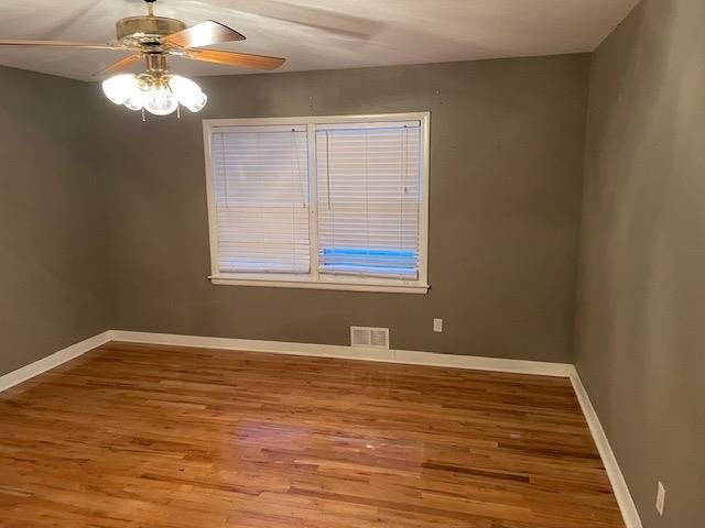 3018 32nd Street Lubbock, TX 79410 - Photo 20 of 33 a view of an empty room with window and wooden floor