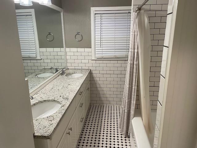 3018 32nd Street Lubbock, TX 79410 - Photo 21 of 33 a bathroom with a granite countertop sink a toilet and shower