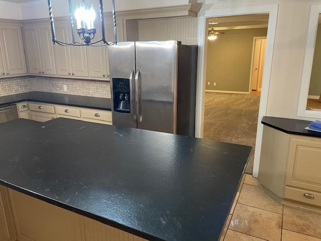 3018 32nd Street Lubbock, TX 79410 - Photo 9 of 33 a view of a refrigerator in kitchen and an empty room with wooden floor