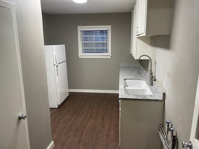 3018 32nd Street Lubbock, TX 79410 - Photo 10 of 33 a kitchen with a sink a refrigerator and cabinets