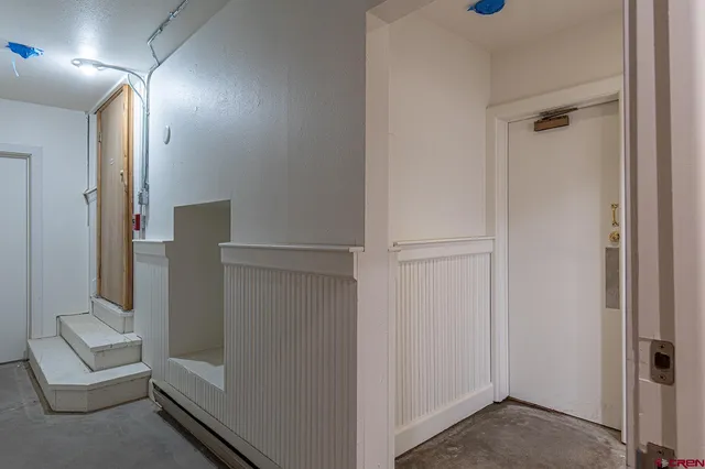 a bathroom with a granite countertop toilet and a sink
