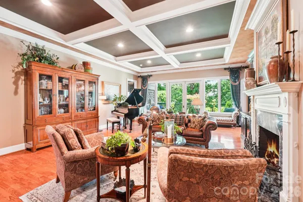 a living room with furniture a fireplace and a large window