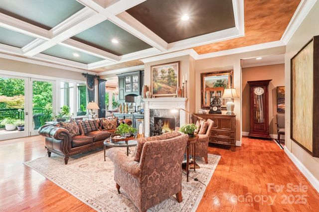 a living room with fireplace furniture and a large window