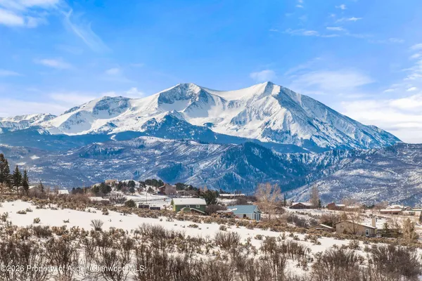 a view of a town with mountains in the background