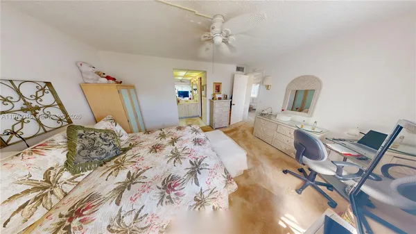 a bedroom with a bed and ceiling fan