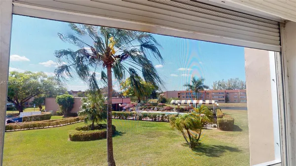 a view of swimming pool with outdoor seating and a patio