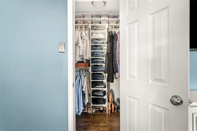 a view of walk in closet with clothes and shoes