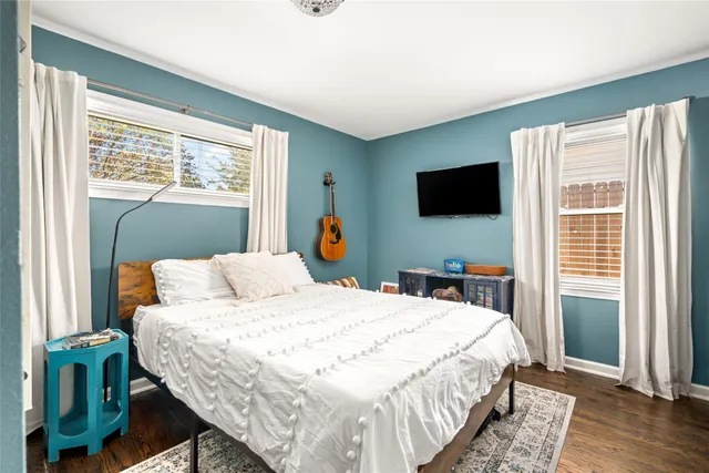 a bedroom with a bed and a flat screen tv