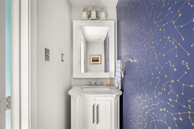 a bathroom with a sink mirror and vanity