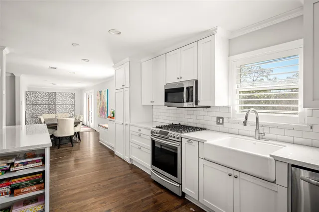 a kitchen with a sink stove and cabinets