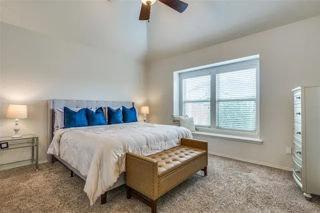 a bed sitting in a bedroom next to a window