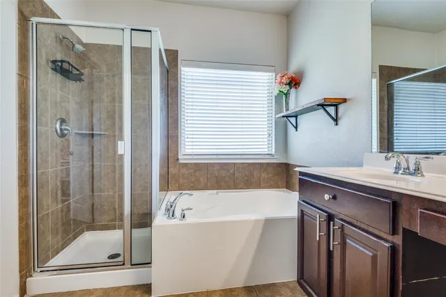 a bathroom with a tub sink and mirror