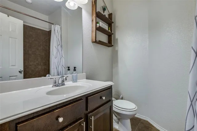 a bathroom with a sink a toilet and mirror