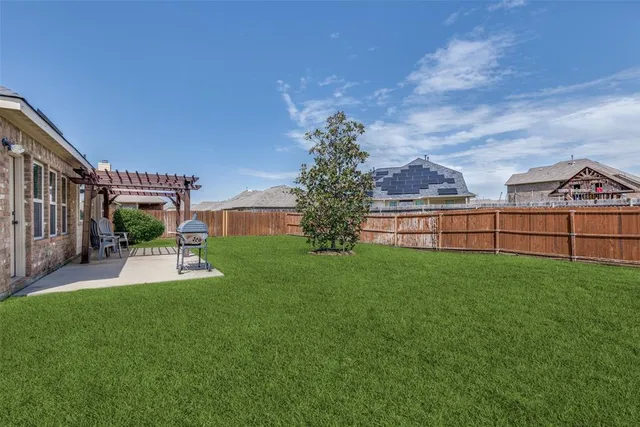 a view of house with backyard and deck