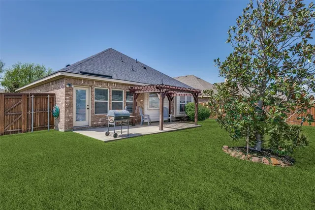 a view of a house with backyard porch and sitting area
