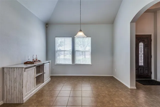 a kitchen with granite countertop a stove and a wooden floors