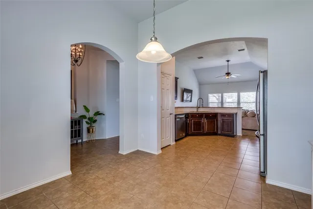 a view of a kitchen with a sink and a refrigerator