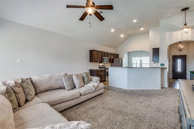 a living room with furniture and kitchen view