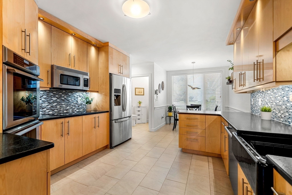 12 Highwood Lane Ipswich, MA 01938 - Photo 12 of 42 a large kitchen with stainless steel appliances granite countertop a stove and a sink