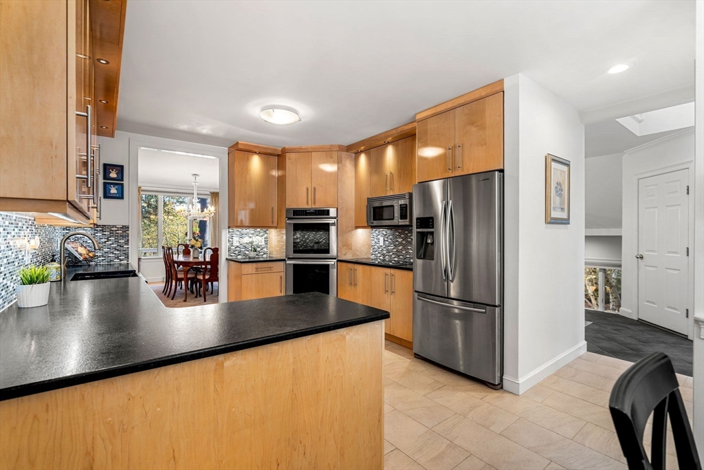 12 Highwood Lane Ipswich, MA 01938 - Photo 13 of 42 a kitchen with stainless steel appliances granite countertop a refrigerator a stove a sink a oven with white cabinets and wooden cabinets