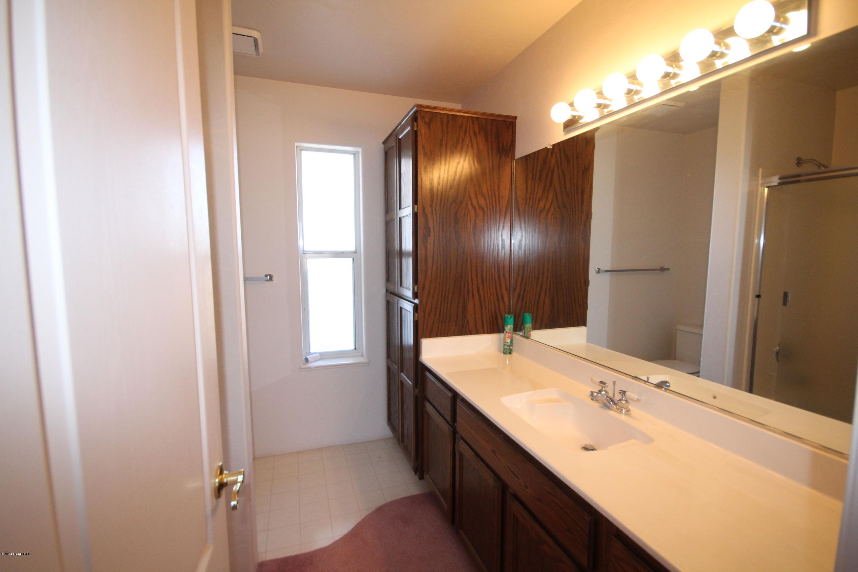 3221 North Reed Road Chino Valley, AZ 86323 - Photo 10 of 24 a bathroom with a double vanity sink and a mirror