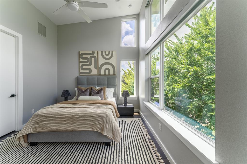 4620 Munger Avenue, Unit 107 Dallas, TX 75204 - Photo 11 of 28 a bedroom with a bed and a large window with balcony view